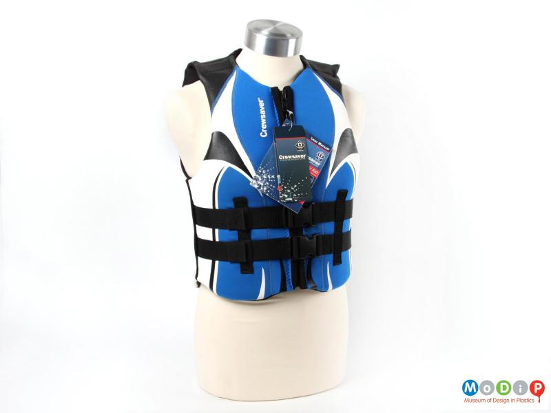 Front view of a Crewsaver buoyancy aid showing the front fastenings and the swing tags.