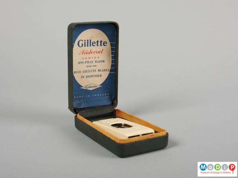 Side view of a razor box showing it open with the razor blade dispenser.