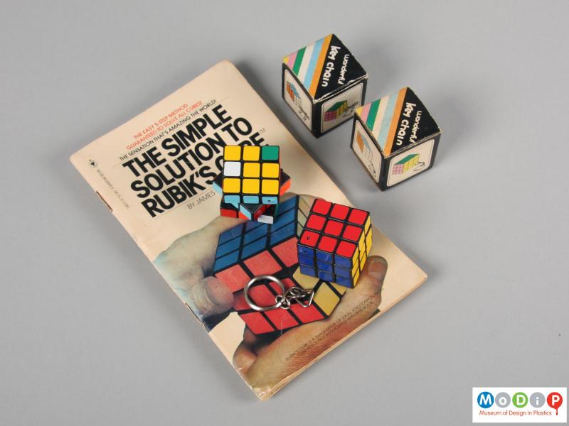 Top view of a puzzle key chain showing both puzzles, the boxes and the book.