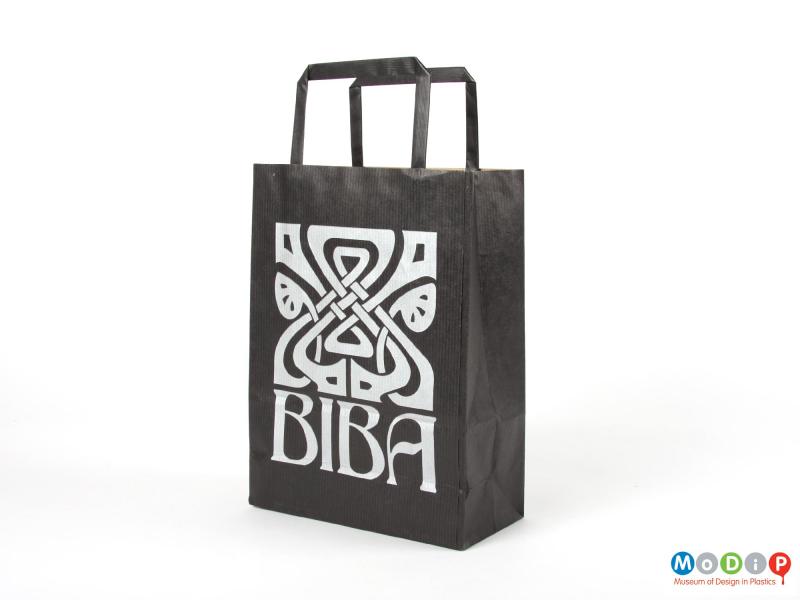 Side view of a paper carrier bag showing the printed logo.