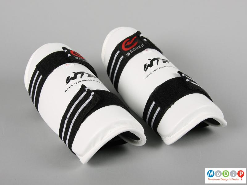 Side view of a pair of arm protectors showing the moulded shape.
