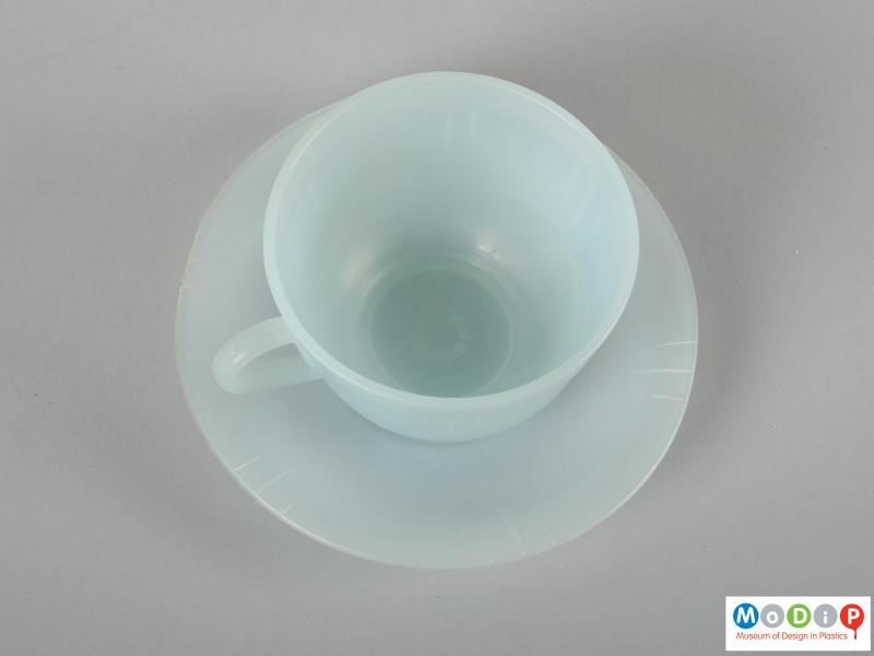 Top view of a cup and saucer showing the handle.