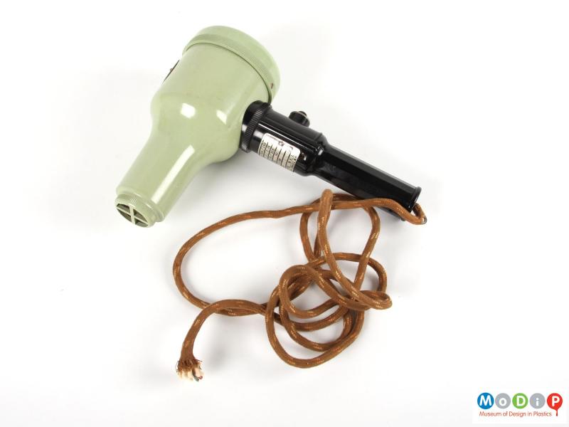Side view of a hairdryer showing bottle shaped body.