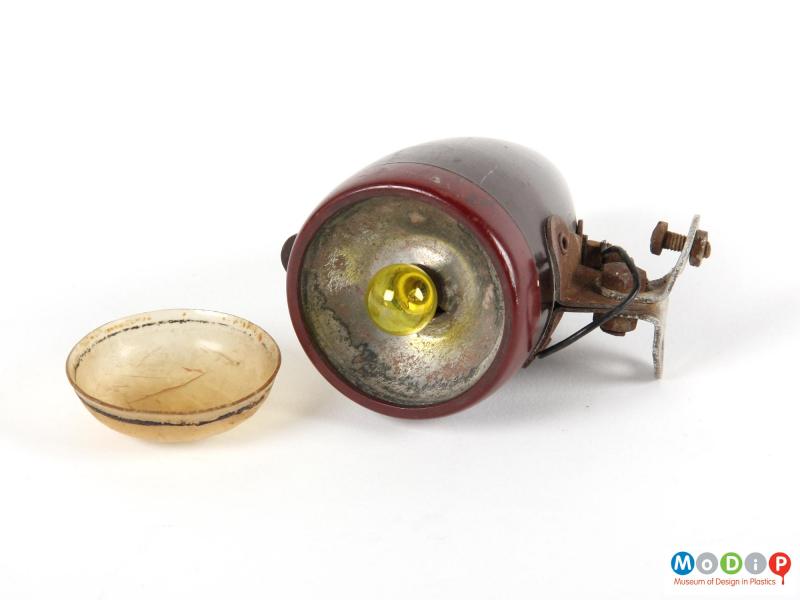 Front view of a bike light showing the lens removed to expose the bulb.