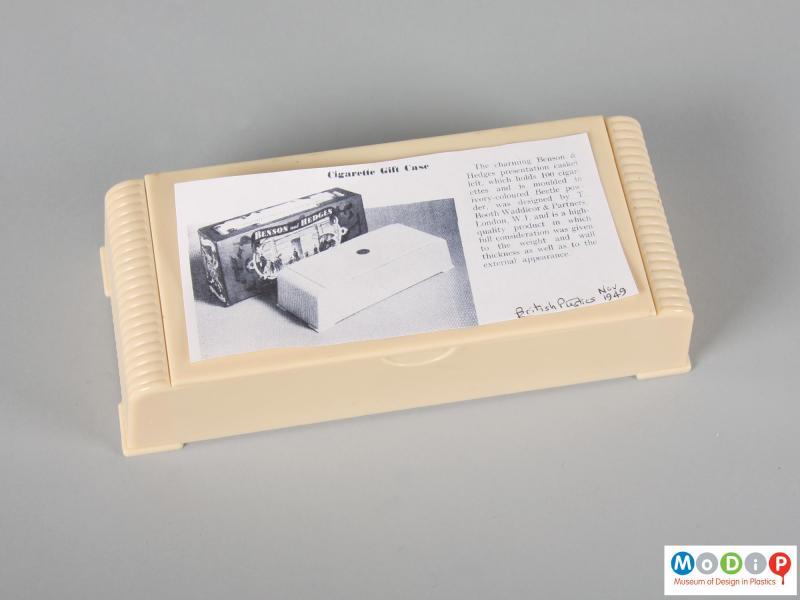 Top view of a cigarette case showing a photocopied article.