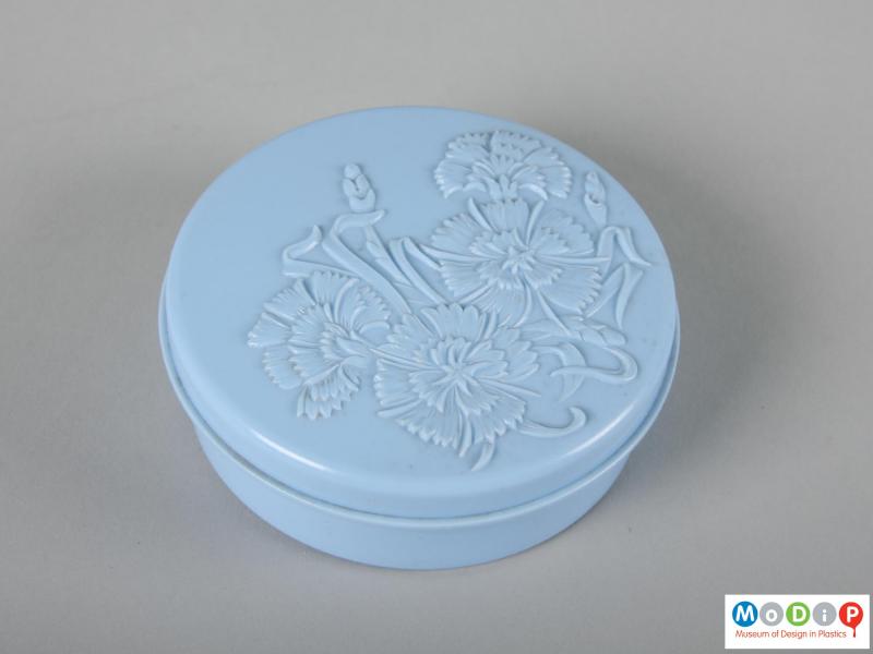 Top view of a powder pot showing the moulded cornflower decoration in the lid.