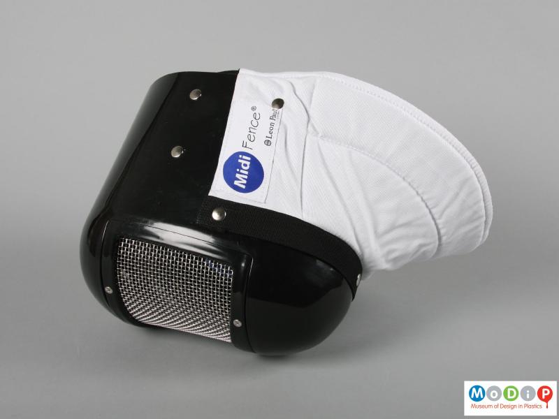 Side view of a fencing mask showing the neck covering.