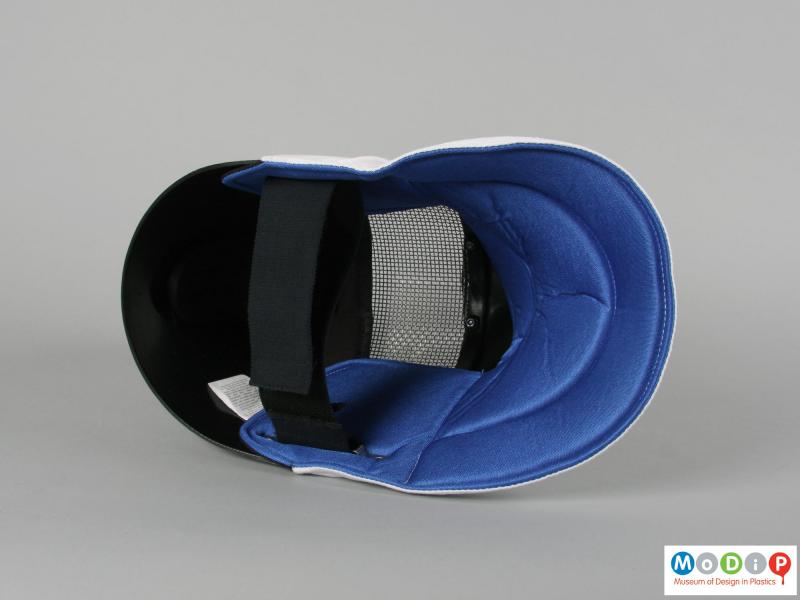 Inside view of a fencing mask showing the internal surface.