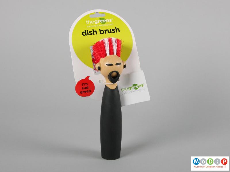 Front view of a dish brush showing the packaging.
