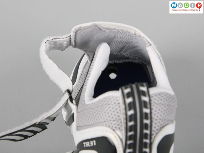 Close view of a pair of triathlon shoes showing the drainage hole in the sole.