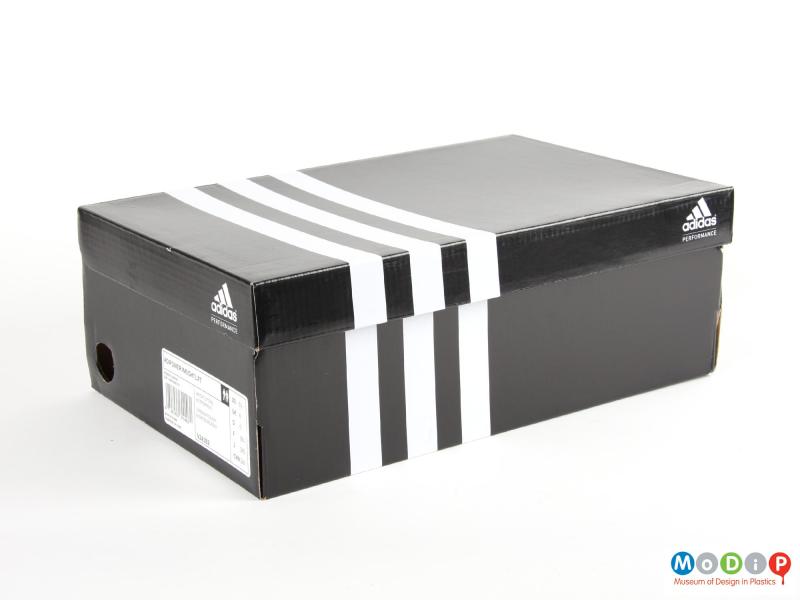 Side view of a pair of weightlifting shoes showing the packaging.