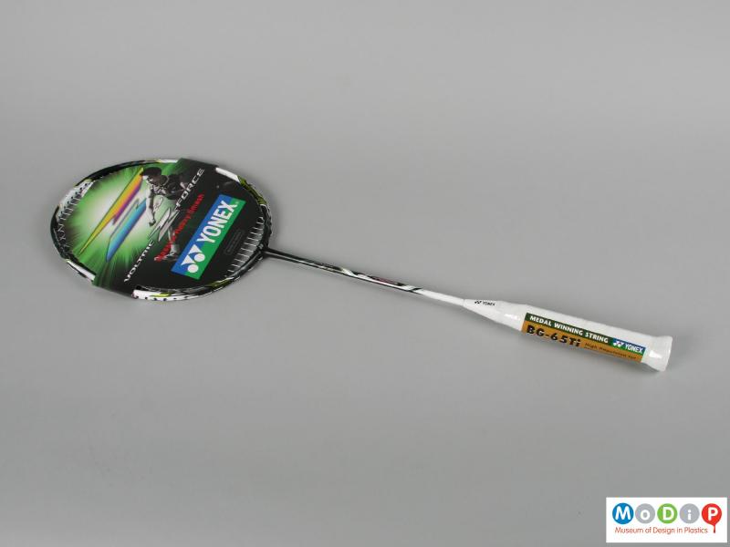 Side view of a badminton racket showing the printed information card.
