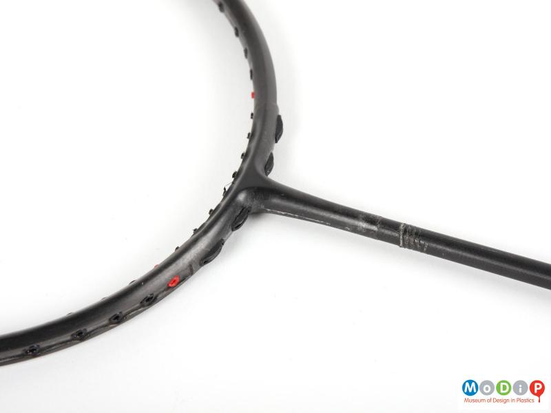 Close view of an unfinished badminton racket showing the join between the head and the handle.