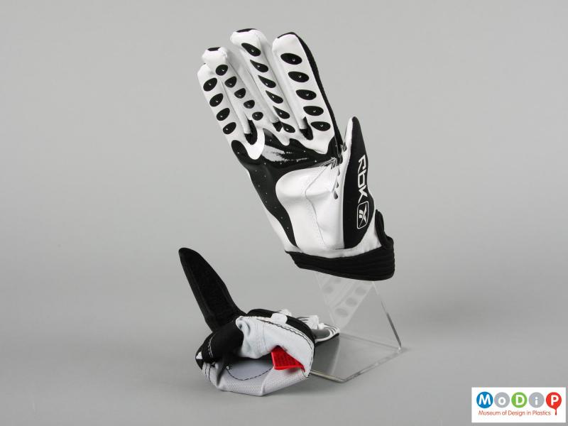 Side view of a pair of wheelchair sports gloves showing the interior of the glove.