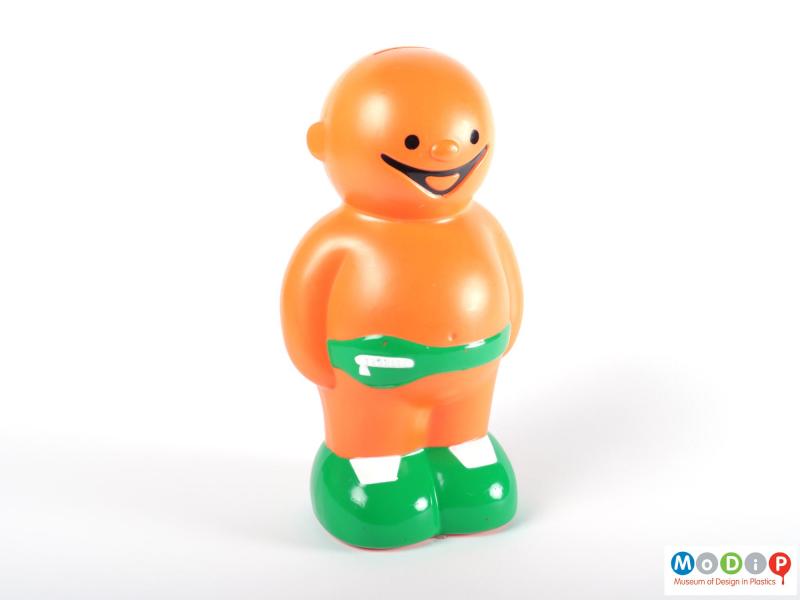 Front view of a money box showing the round body and face of the Jelly baby.