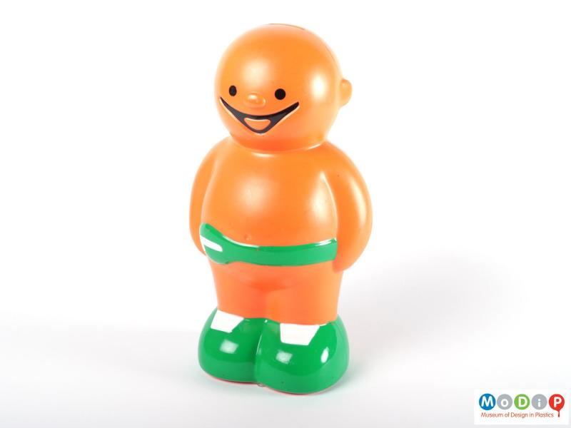 Front view of a money box showing the round body and face of the Jelly baby.