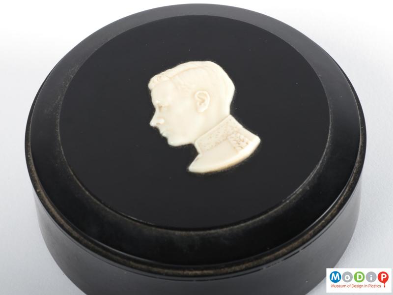Close view of a trinket box showing the cameo style figure on the lid.