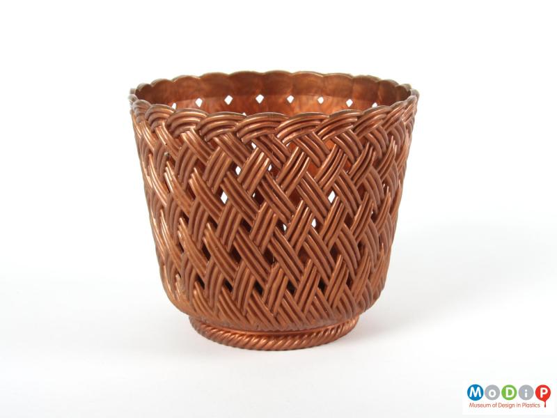 Side view of a plant pot holder showing the basket weave moulded patterning.