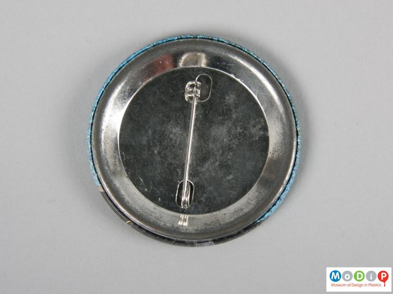 Front view of a pin badge showing the pin fastening.