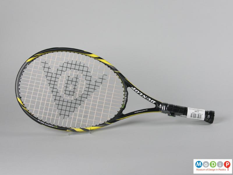 Side view of a tennis racket showing the strings.