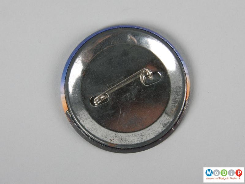 Front view of a pin badge showing the pin fastening.