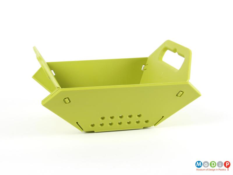 Side view of a colander showing the piece folded and secured.