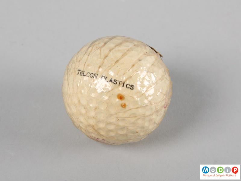 Side view of a golf ball showing the printed inscription.