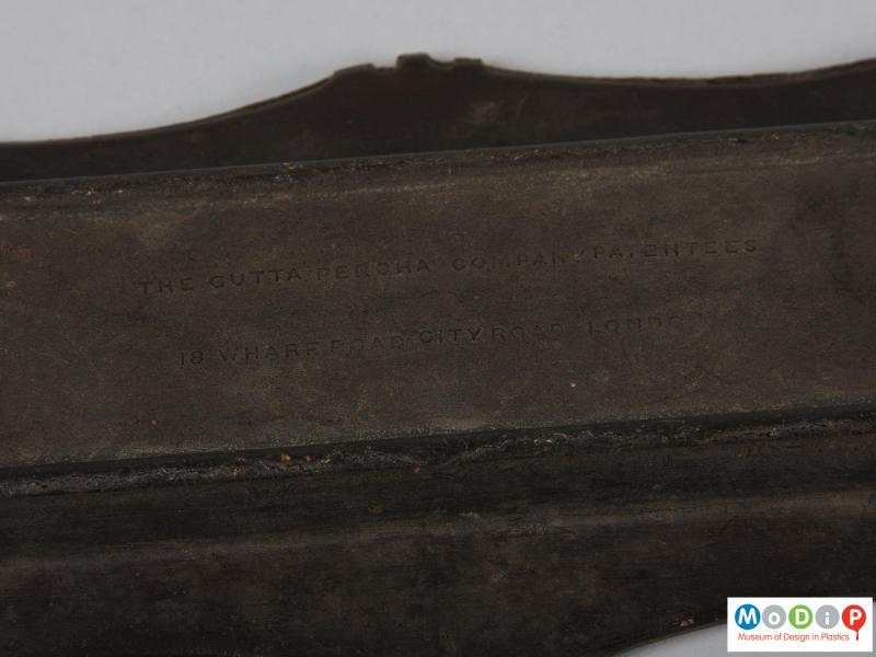 Close view of a pen tray showing the moulded inscription.