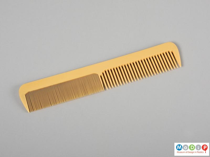 Side view of a comb showing the different sized teeth.