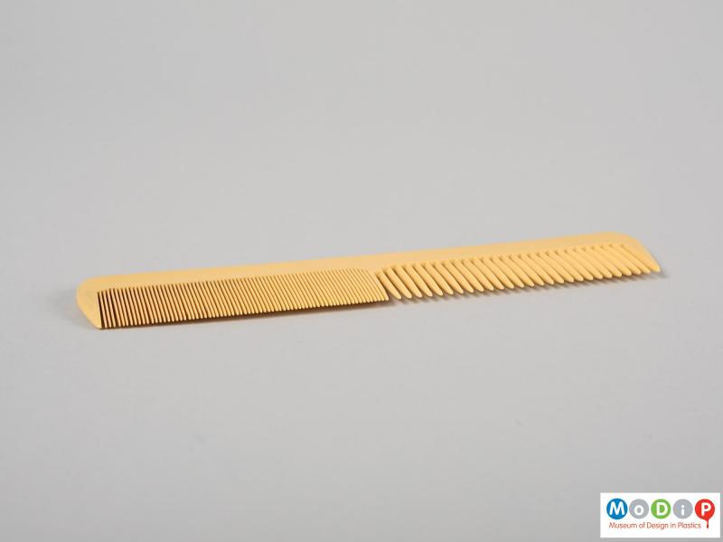 Side view of a comb showing the different sized teeth.