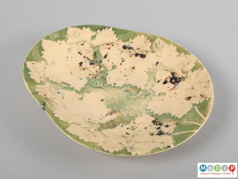 Top view of a fruit dish showing the moulded pattern and applied colour.
