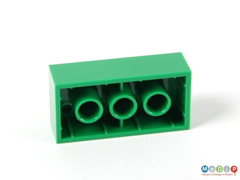 Underside view of a Lego brick showing the space for the pegs in the base.