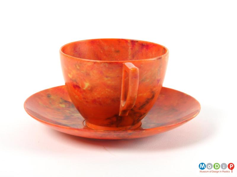 Side view of a cup and saucer showing the smooth sides.