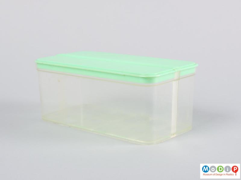 Side view of a food container showing the clear base and green lid.