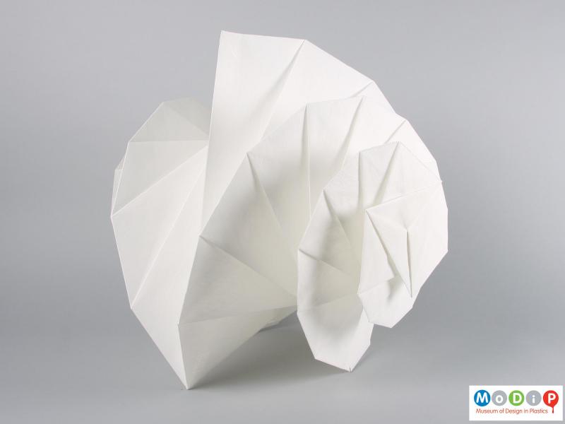 Side view of a lamp showing the turned and folded fabric.