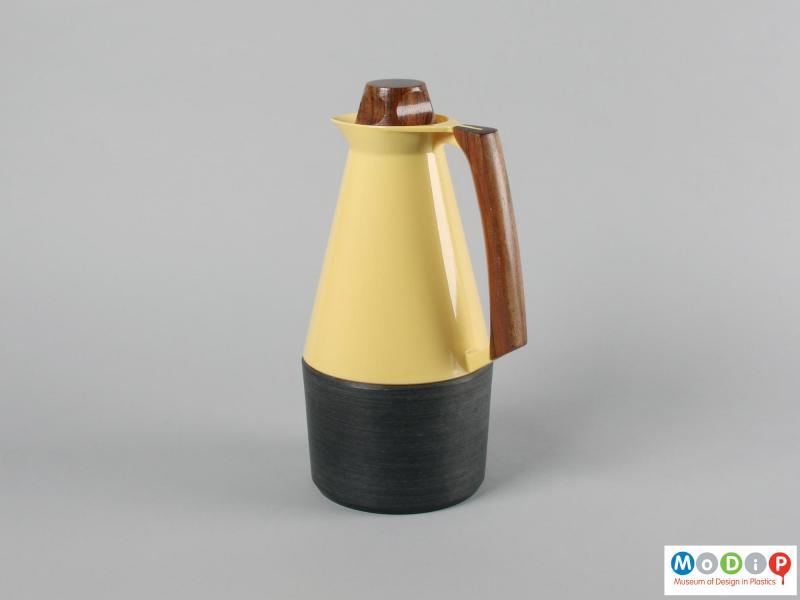 Side view of a coffee pot showing the wooden handle.