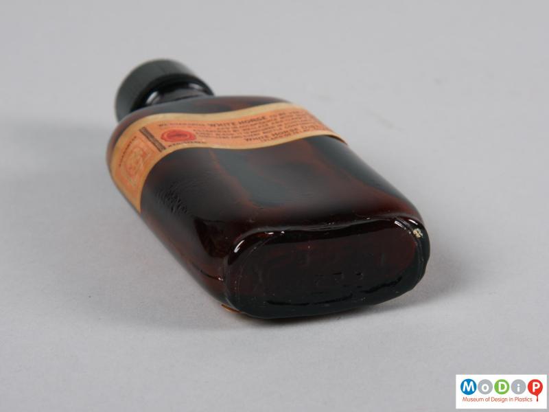 Underside view of a bottle showing the kidney shape.
