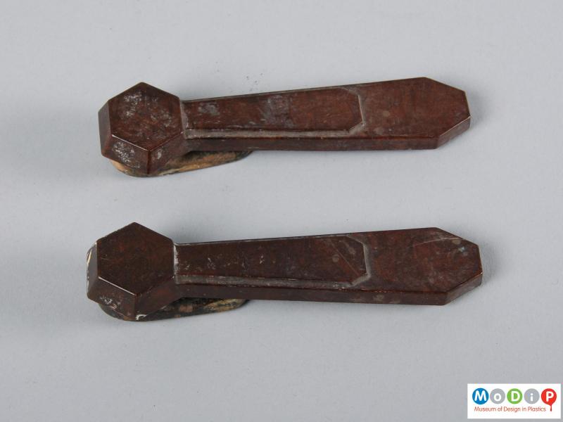 Top view of a pair of stair clips showing the geometric design.