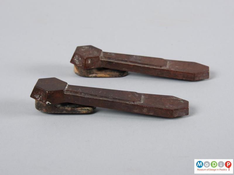 Side view of a pair of stair clips showing the PF top and metal clip.