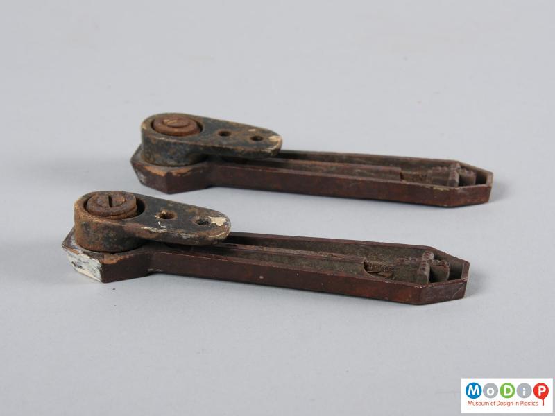 Underside view of a pair of stair clips showing the metal clip underneath.