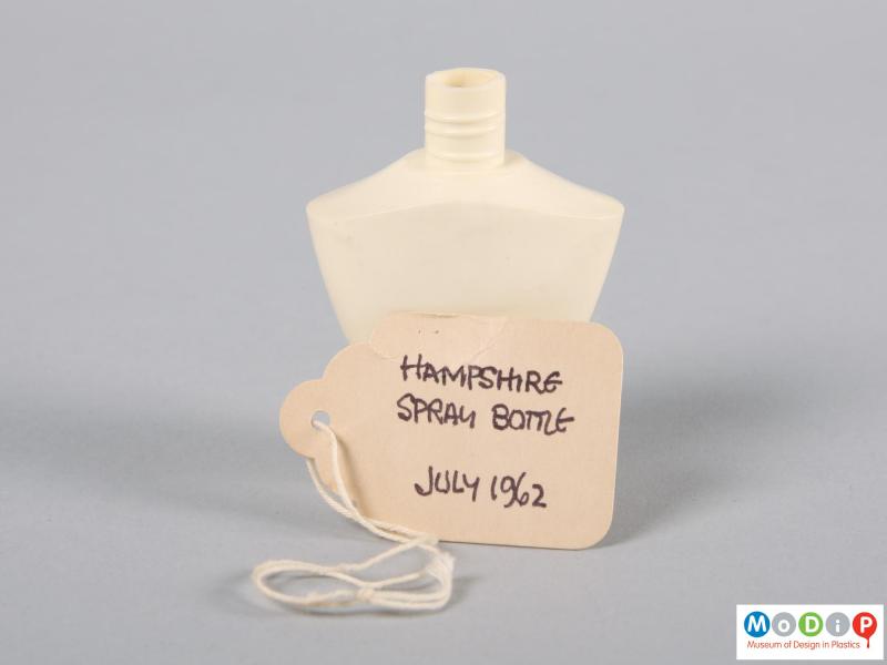Side view of a bottle showing the handwritten label.