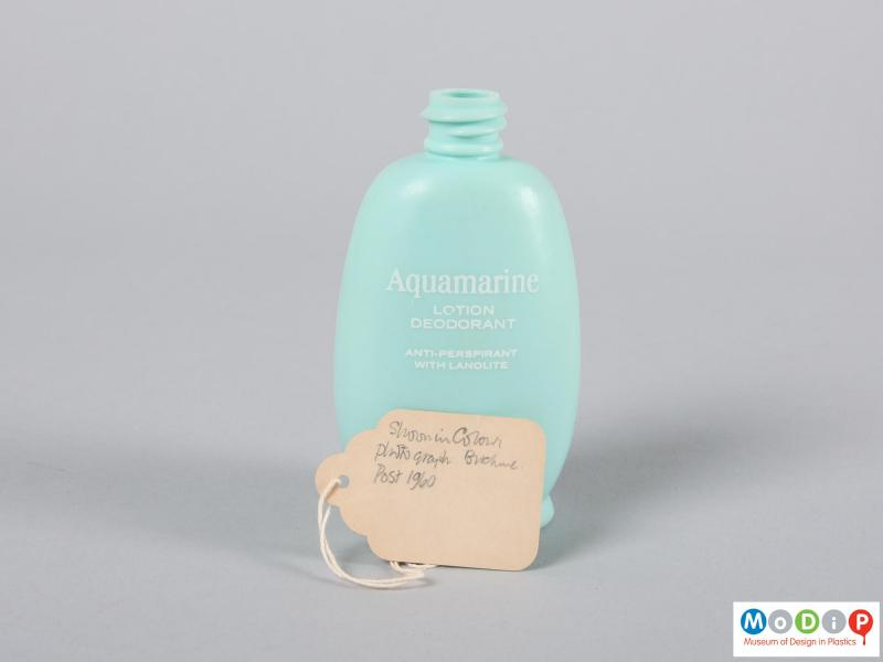 Side view of a bottle showing the handwritten label.