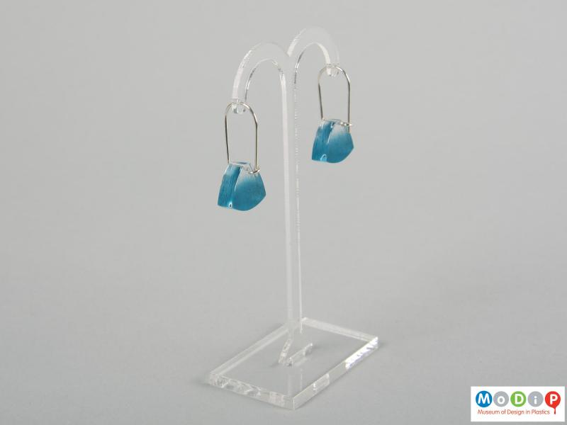 Side view of a pair of earrings showing the clear material.