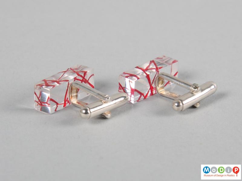 Rear view of a pair of cuff links showing the clear material.