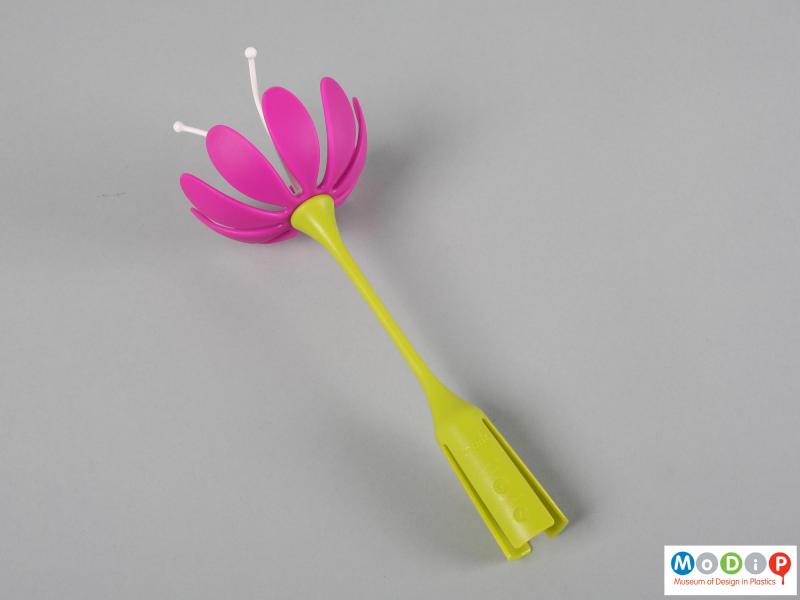 Side view of a drying tray accessory showing the flower shape.