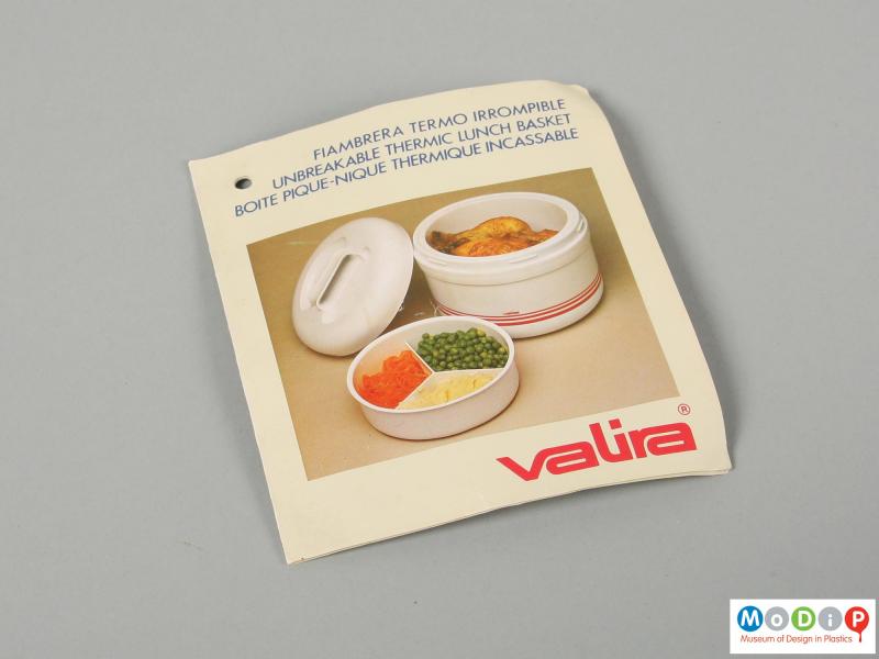 Close view of a lunch box showing sales leaflet.