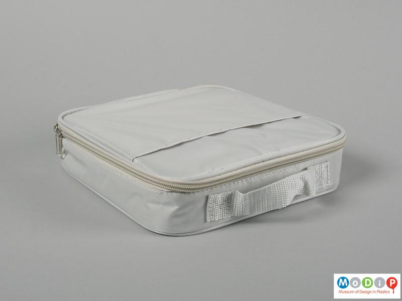Side view of a lunch box showing the carrying bag.