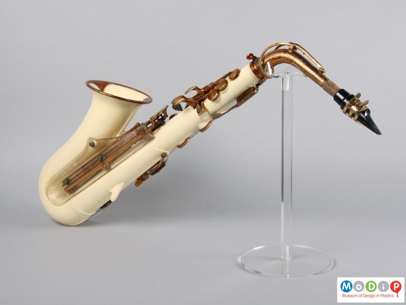 Side view of a saxophone showing the cream coloured body.