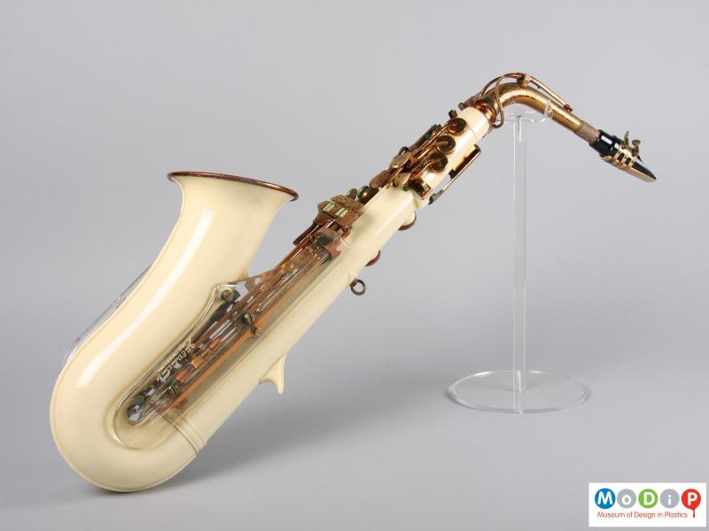 Side view of a saxophone showing the cream coloured body.