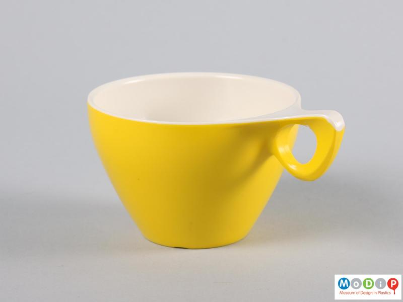 Side view of a cup showing the white extending over the handle.